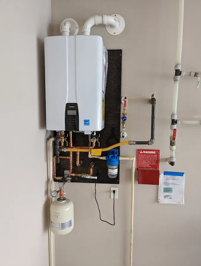 Professional plumber installing copper piping in a Brigantine home